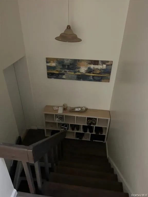 Staircase featuring baseboards Staircase featuring baseboards