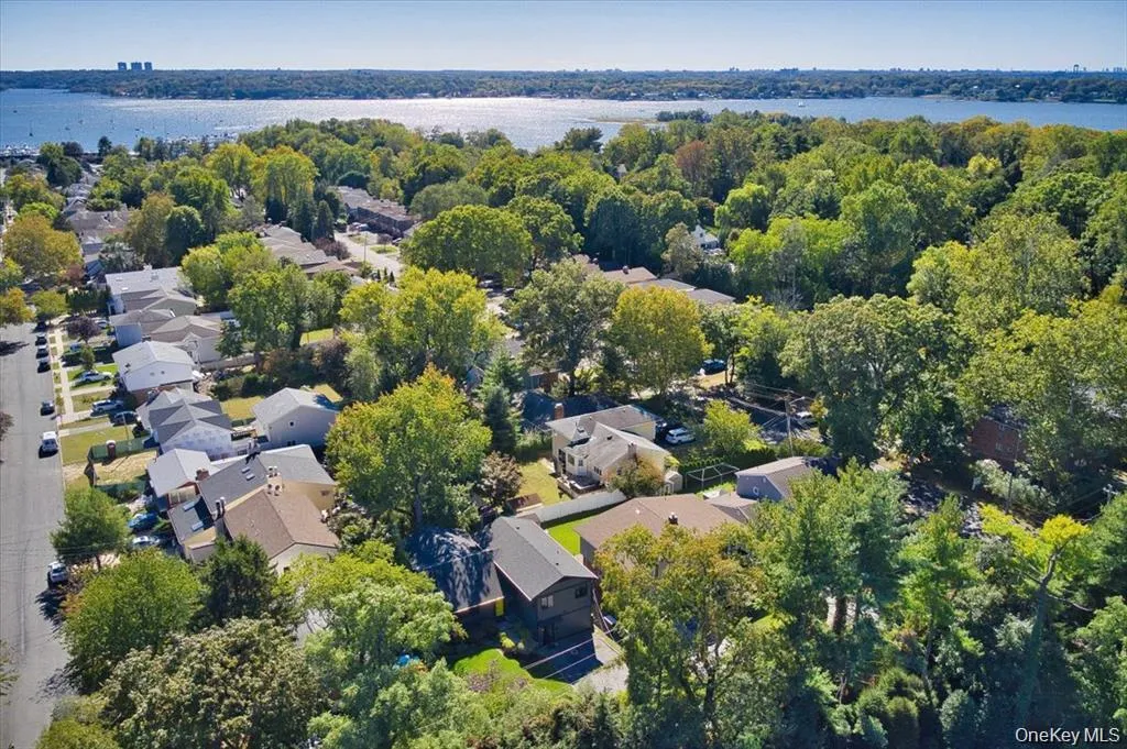 Aerial overview of property's location featuring nearby suburban area and a nearby body of water Aerial overview of property's location featuring nearby suburban area and a nearby body of water