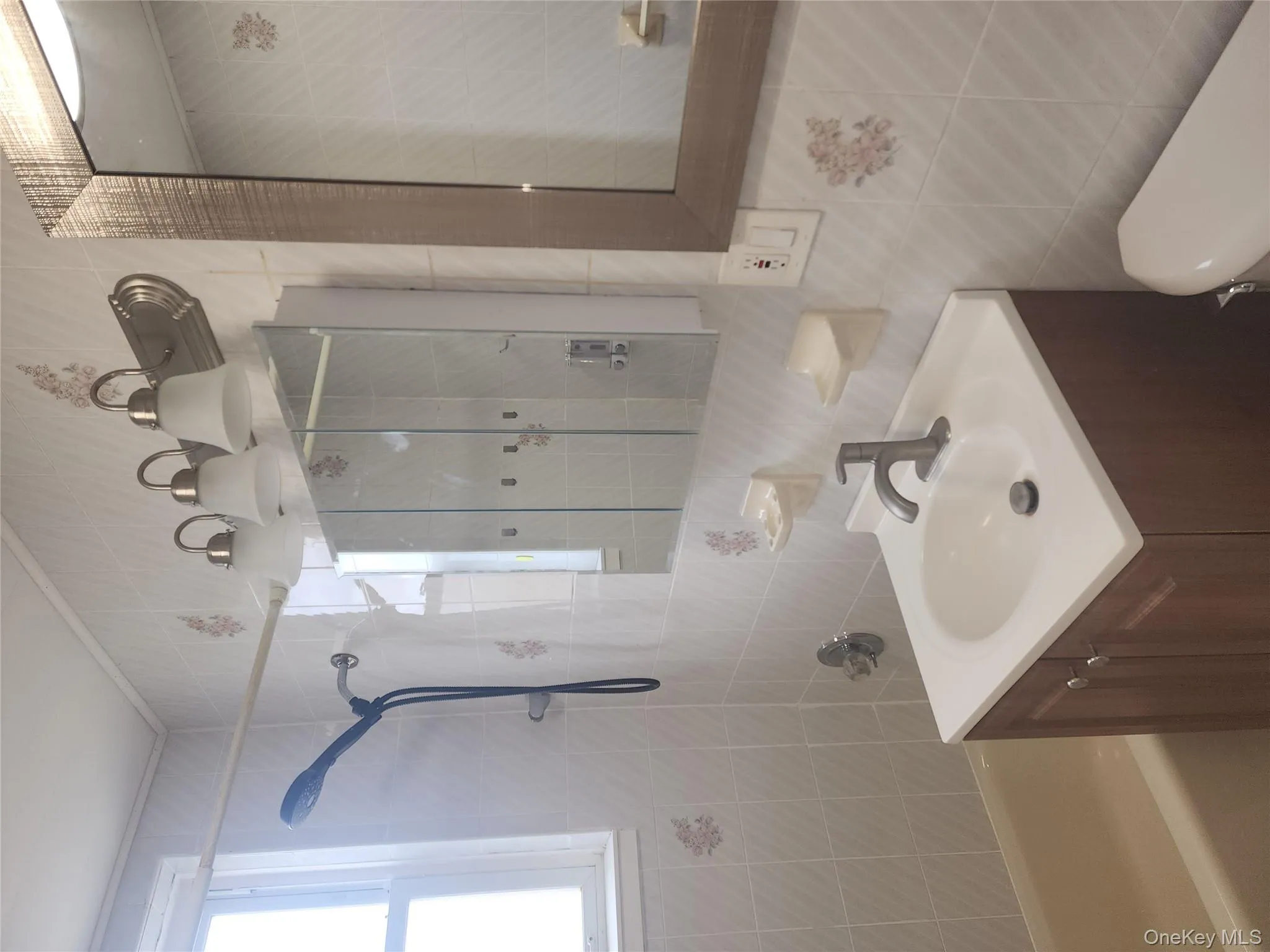 Full bathroom featuring tile walls, vanity,  shower combination, and backsplash Full bathroom featuring tile walls, vanity,  shower combination, and backsplash