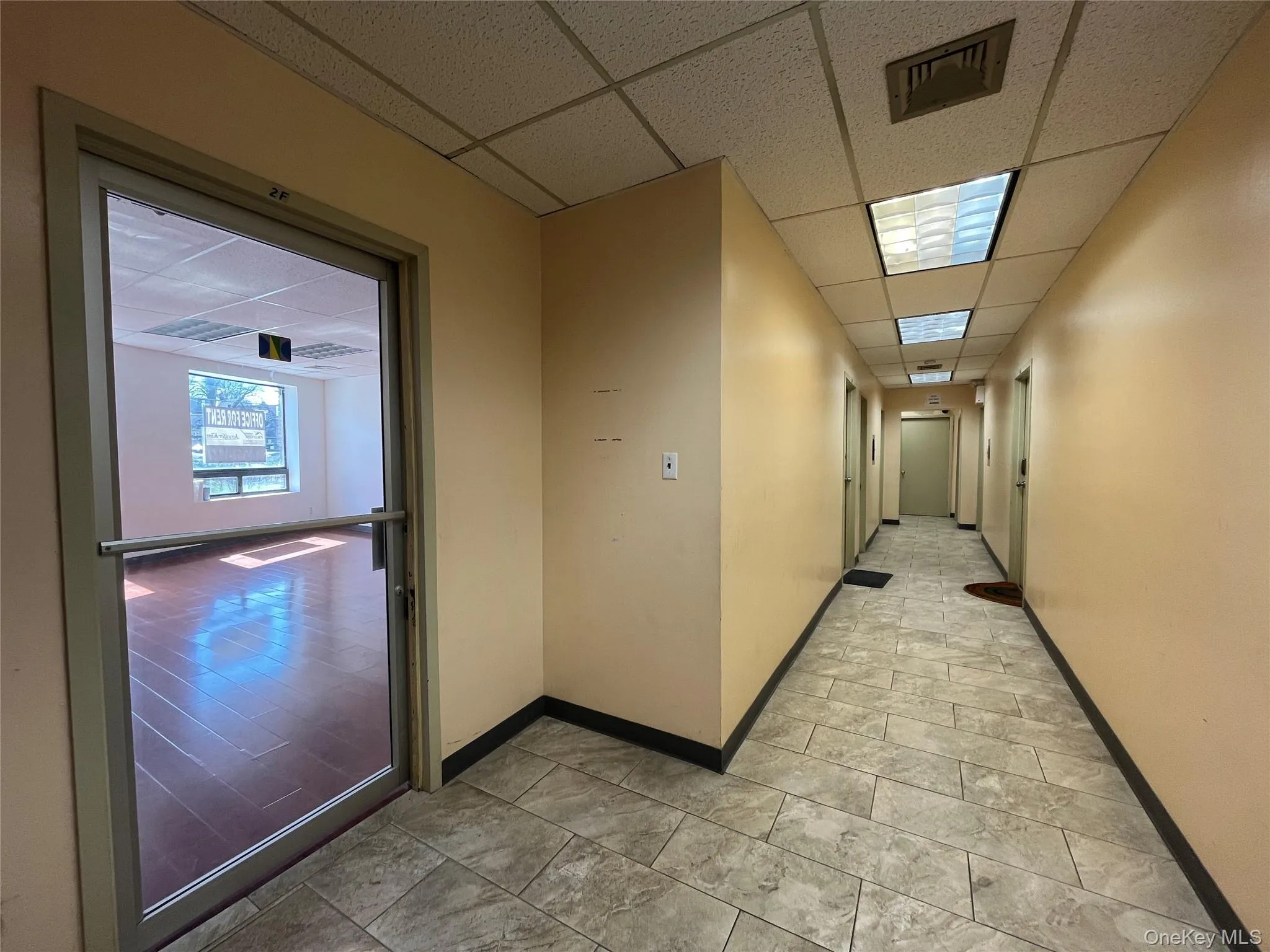 Hallway featuring a drop ceiling Hallway featuring a drop ceiling