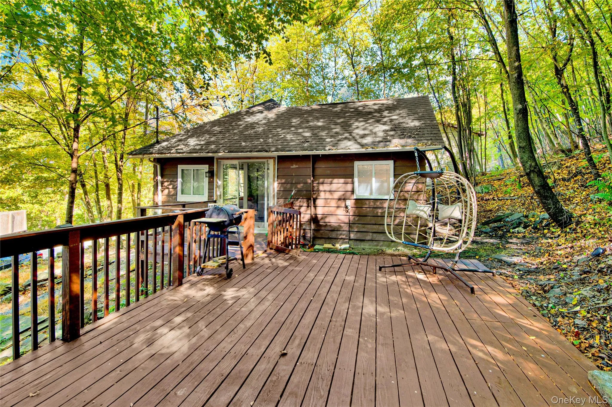 Deck with area for grilling and view of scattered trees Deck with area for grilling and view of scattered trees
