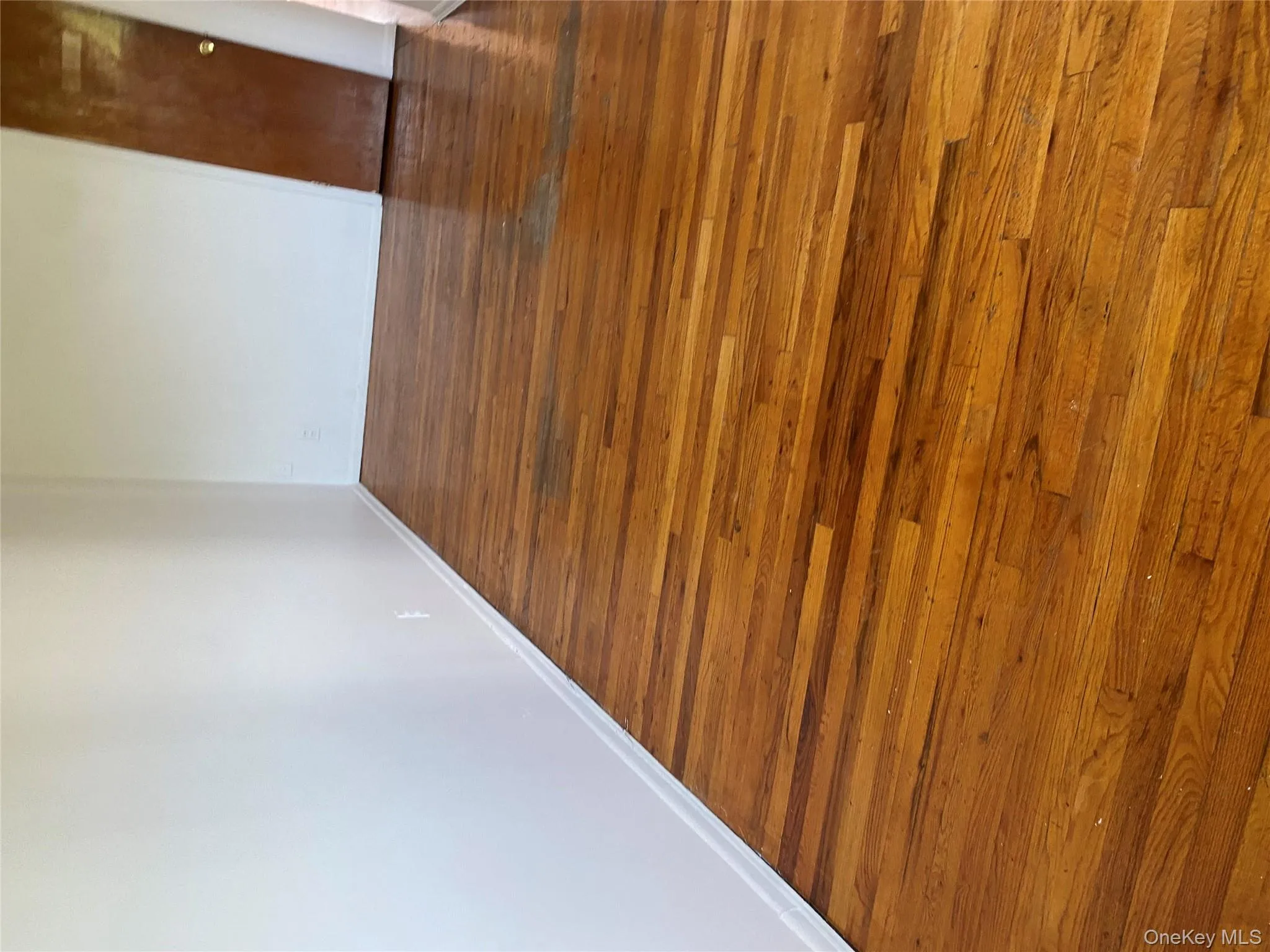 Spare room featuring dark wood finished floors and baseboards Spare room featuring dark wood finished floors and baseboards