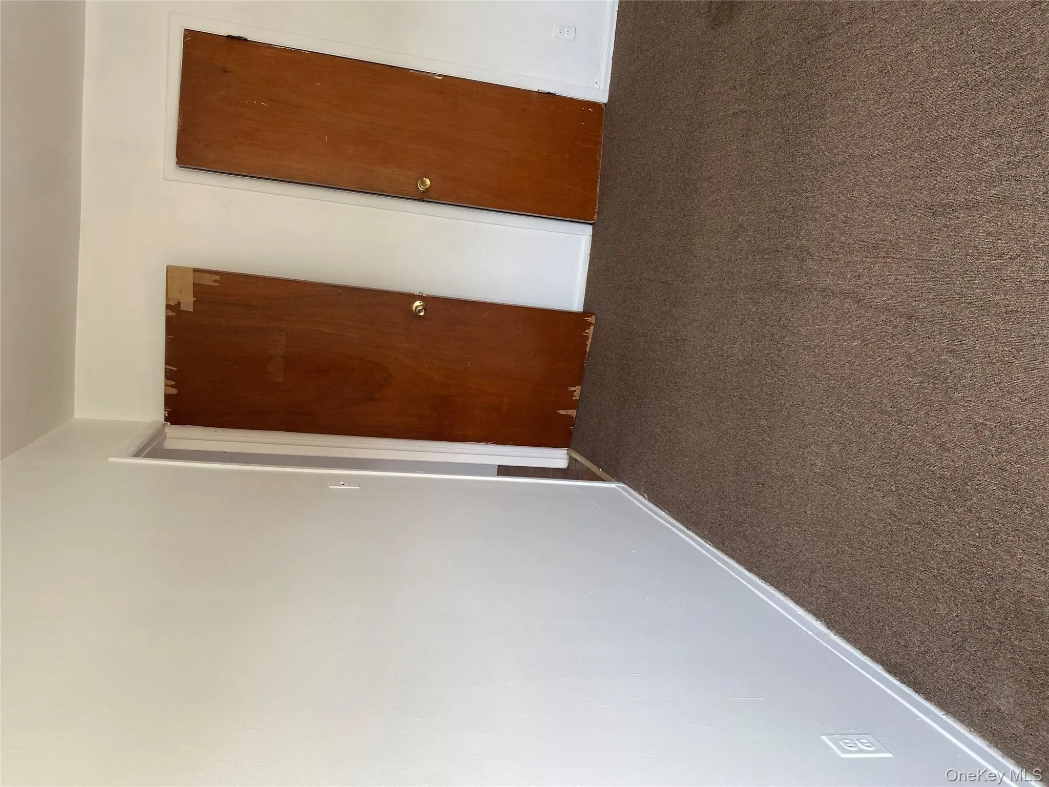 Unfurnished bedroom featuring dark carpet and a closet Unfurnished bedroom featuring dark carpet and a closet