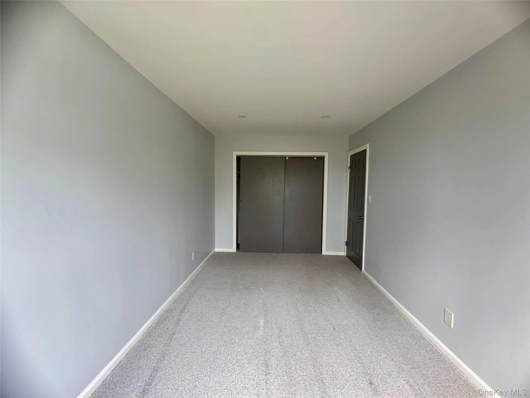 Second bedroom featuring carpet flooring and a closet Second bedroom featuring carpet flooring and a closet