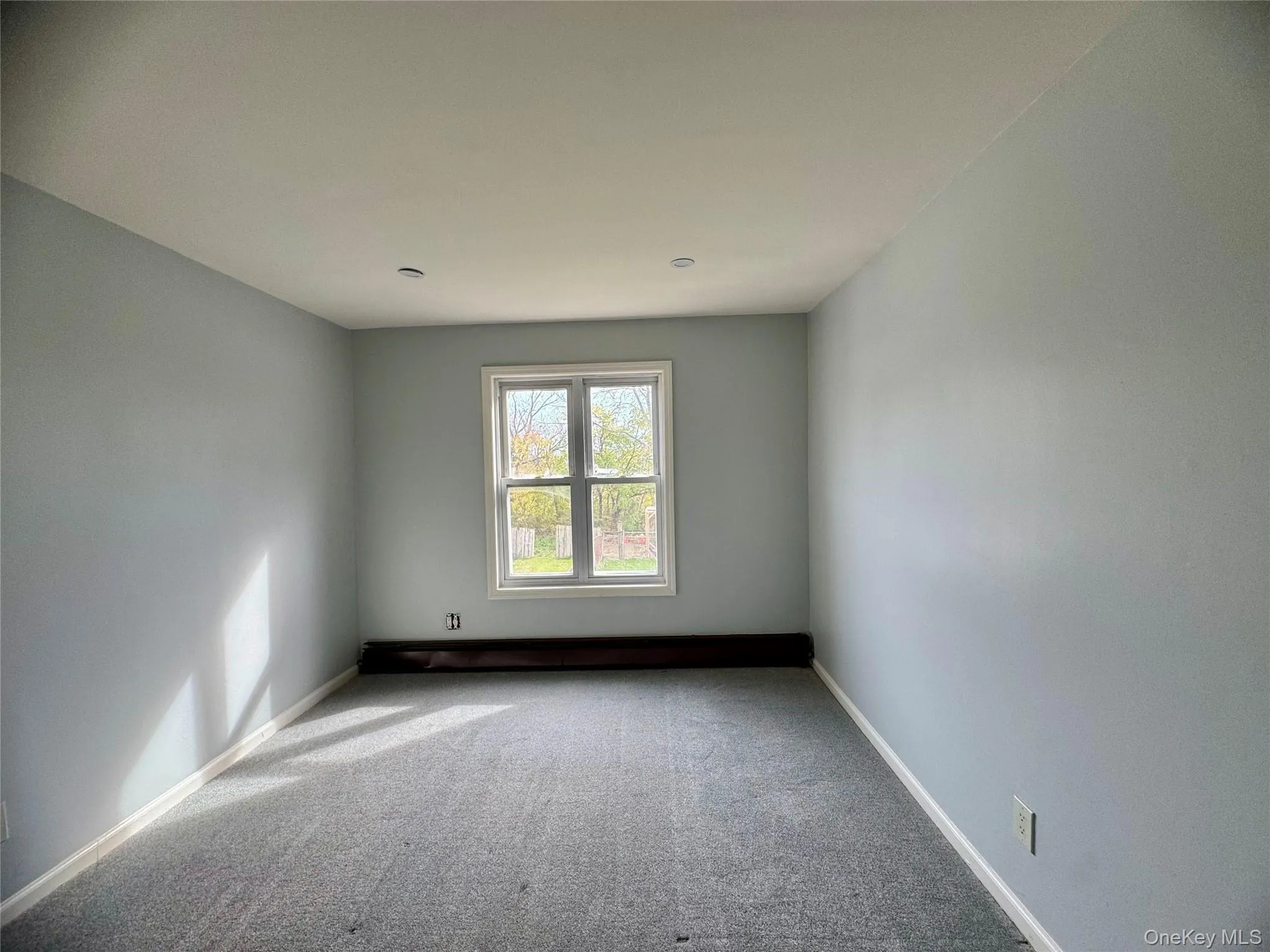 Ensuite, carpeted empty room featuring baseboards Ensuite, carpeted empty room featuring baseboards