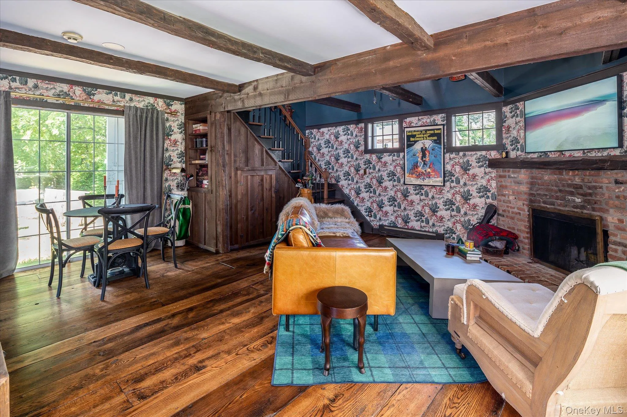 Living room featuring hardwood floors, a fireplace, beamed ceiling Living room featuring hardwood floors, a fireplace, beamed ceiling