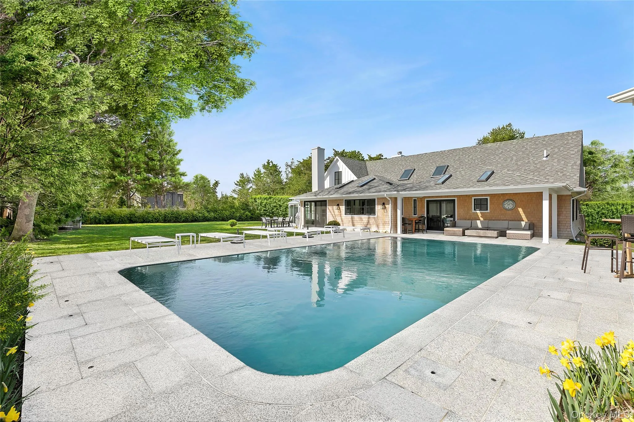 Outdoor pool with an outdoor hangout area, a patio, and a yard Outdoor pool with an outdoor hangout area, a patio, and a yard