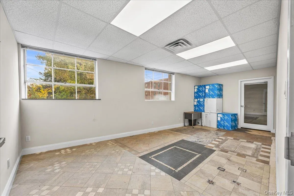 Basement with a drop ceiling and baseboards Basement with a drop ceiling and baseboards