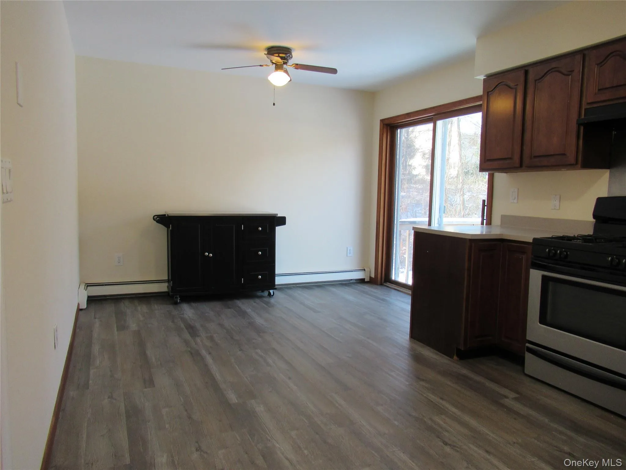 Kitchen featuring luxury vinyl flooring, gas stove and ceiling fan Kitchen featuring luxury vinyl flooring, gas stove and ceiling fan