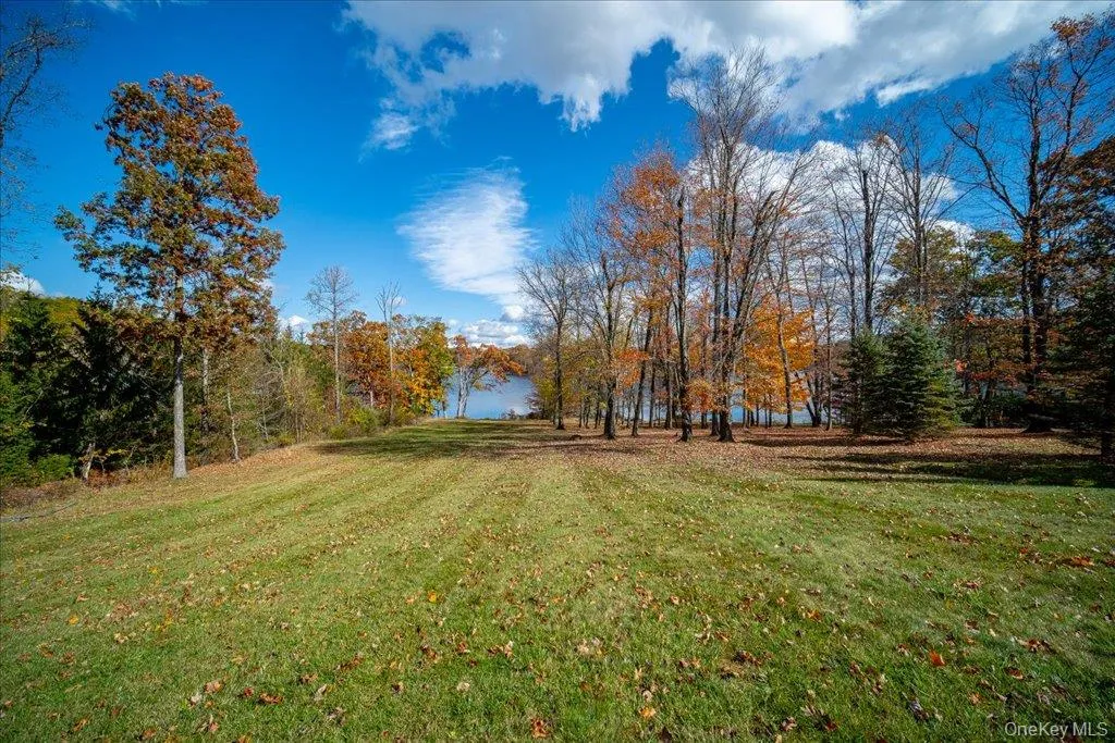 View of grassy yard featuring a water view View of grassy yard featuring a water view