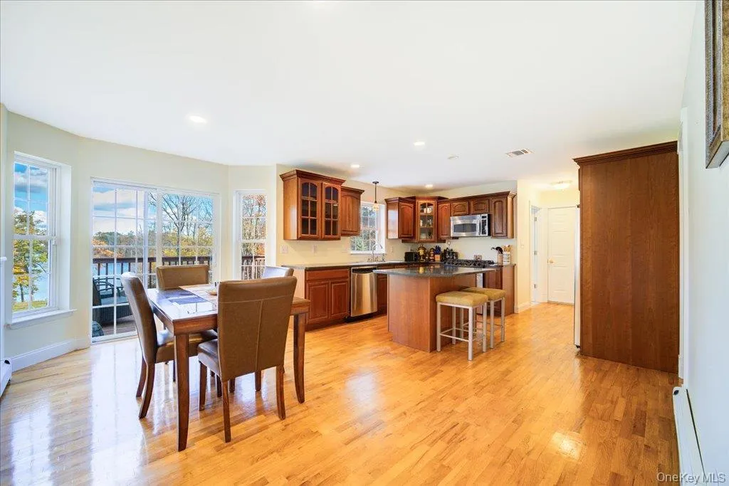 Kitchen with sliding doors to deck overlooking lake Kitchen with sliding doors to deck overlooking lake