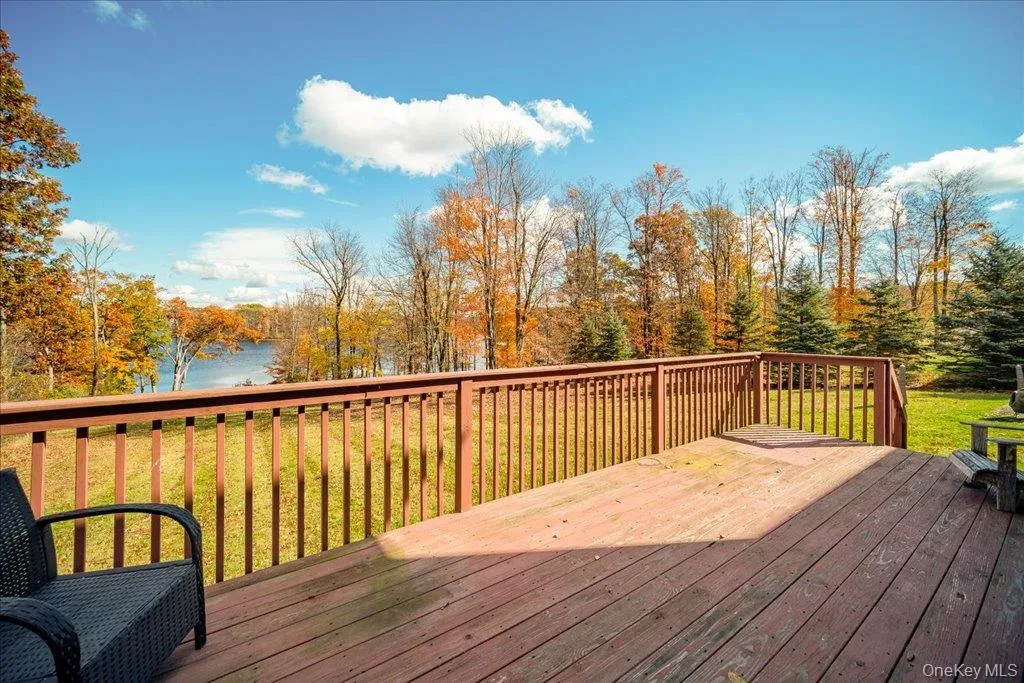 Wooden terrace with a yard and a water view Wooden terrace with a yard and a water view