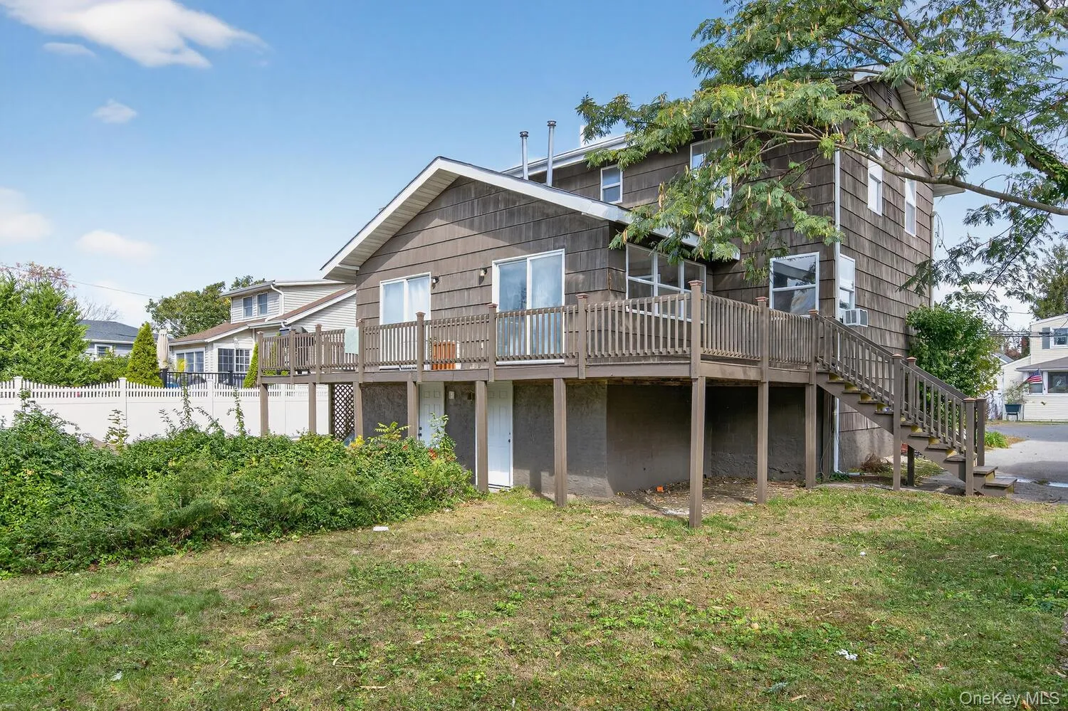 Back of house featuring stairway and a deck Back of house featuring stairway and a deck