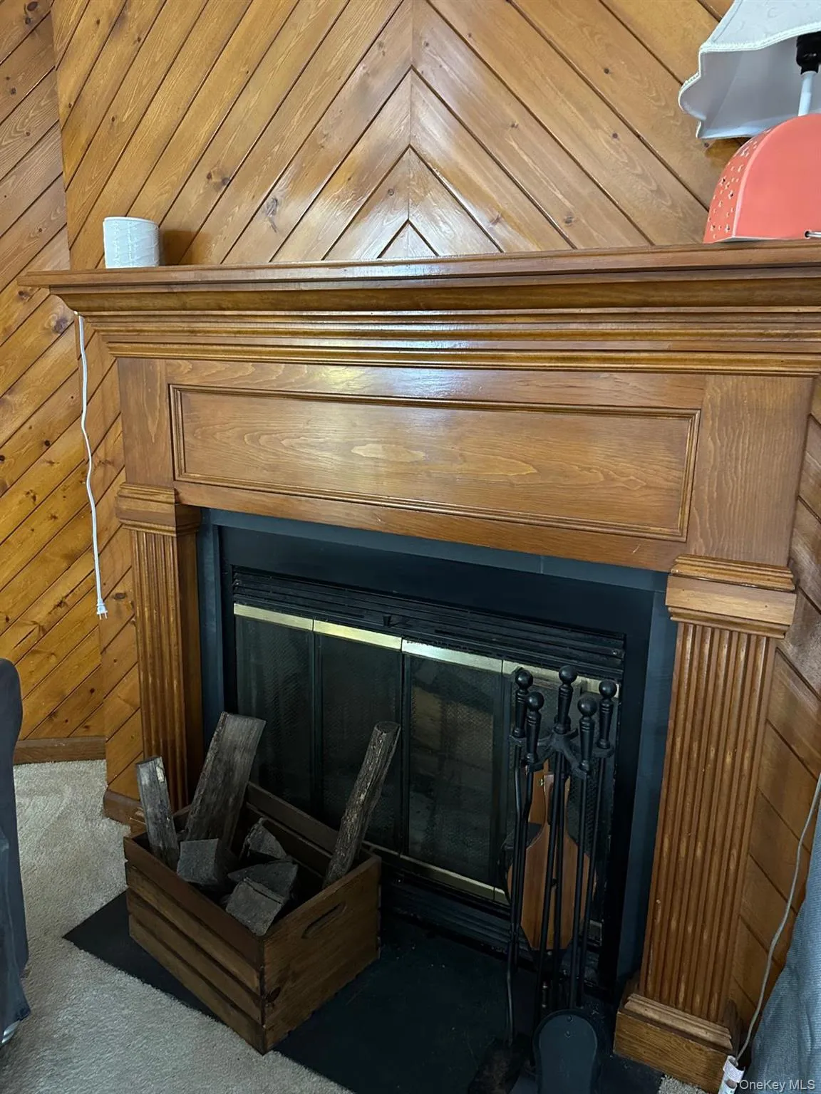 Detailed view of a glass covered fireplace, wood and wall Detailed view of a glass covered fireplace, wood and wall