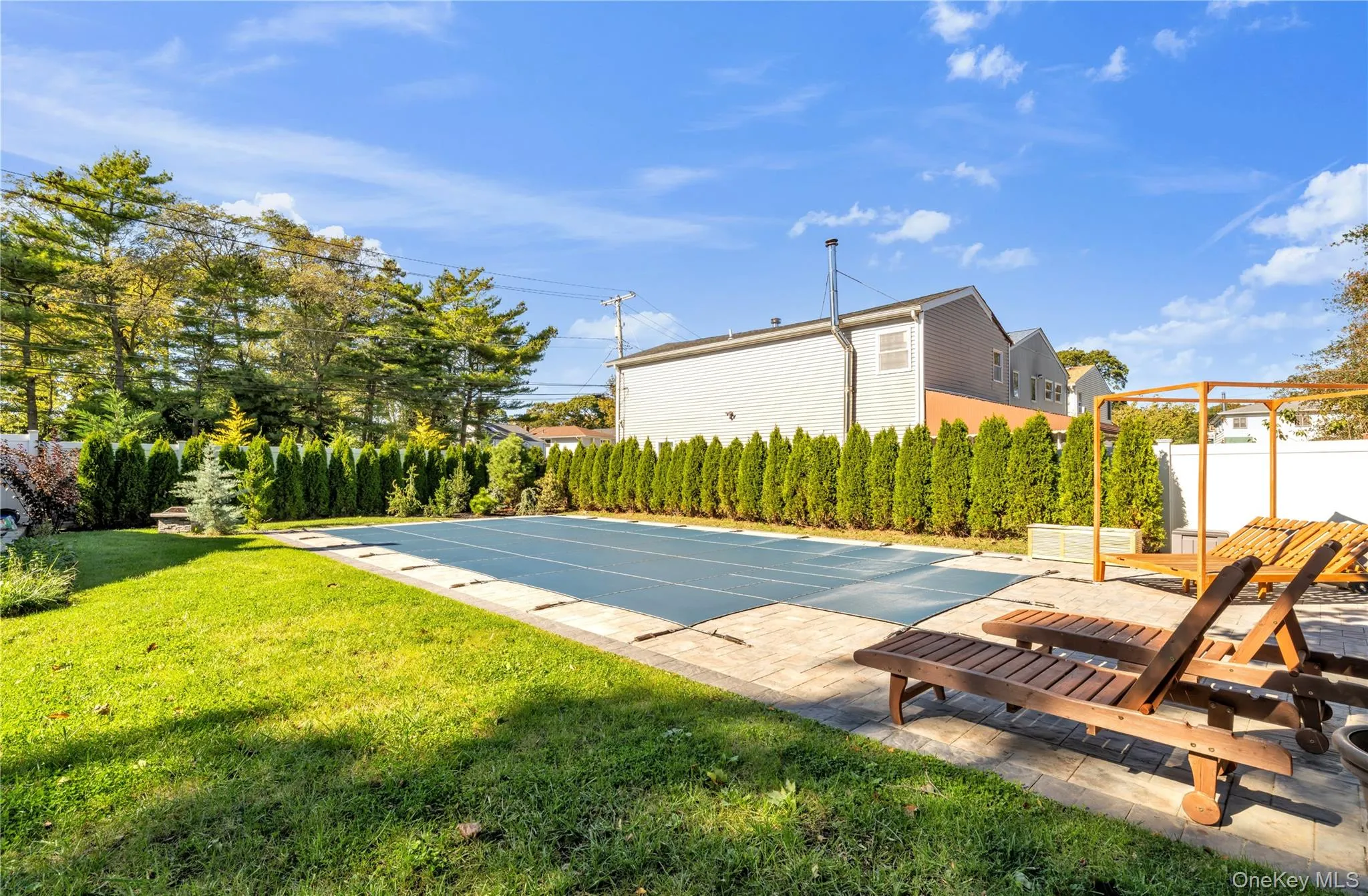View of swimming pool featuring a patio area View of swimming pool featuring a patio area