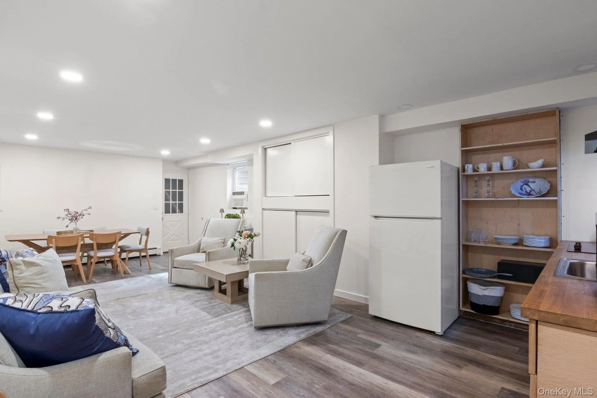 LOWER LEVEL Living room featuring dark wood-style floors and recessed lighting LOWER LEVEL Living room featuring dark wood-style floors and recessed lighting