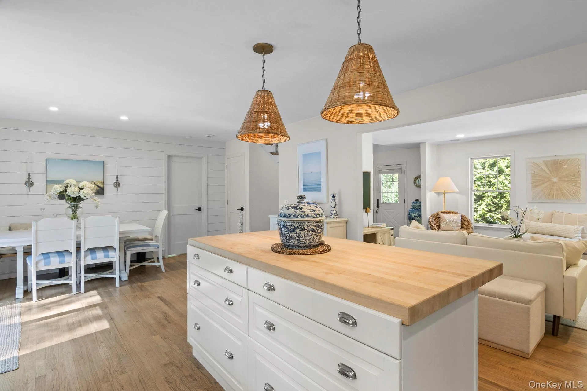 Kitchen featuring butcher block countertops, open floor plan, white cabinets, light wood finished floors, and recessed lighting Kitchen featuring butcher block countertops, open floor plan, white cabinets, light wood finished floors, and recessed lighting