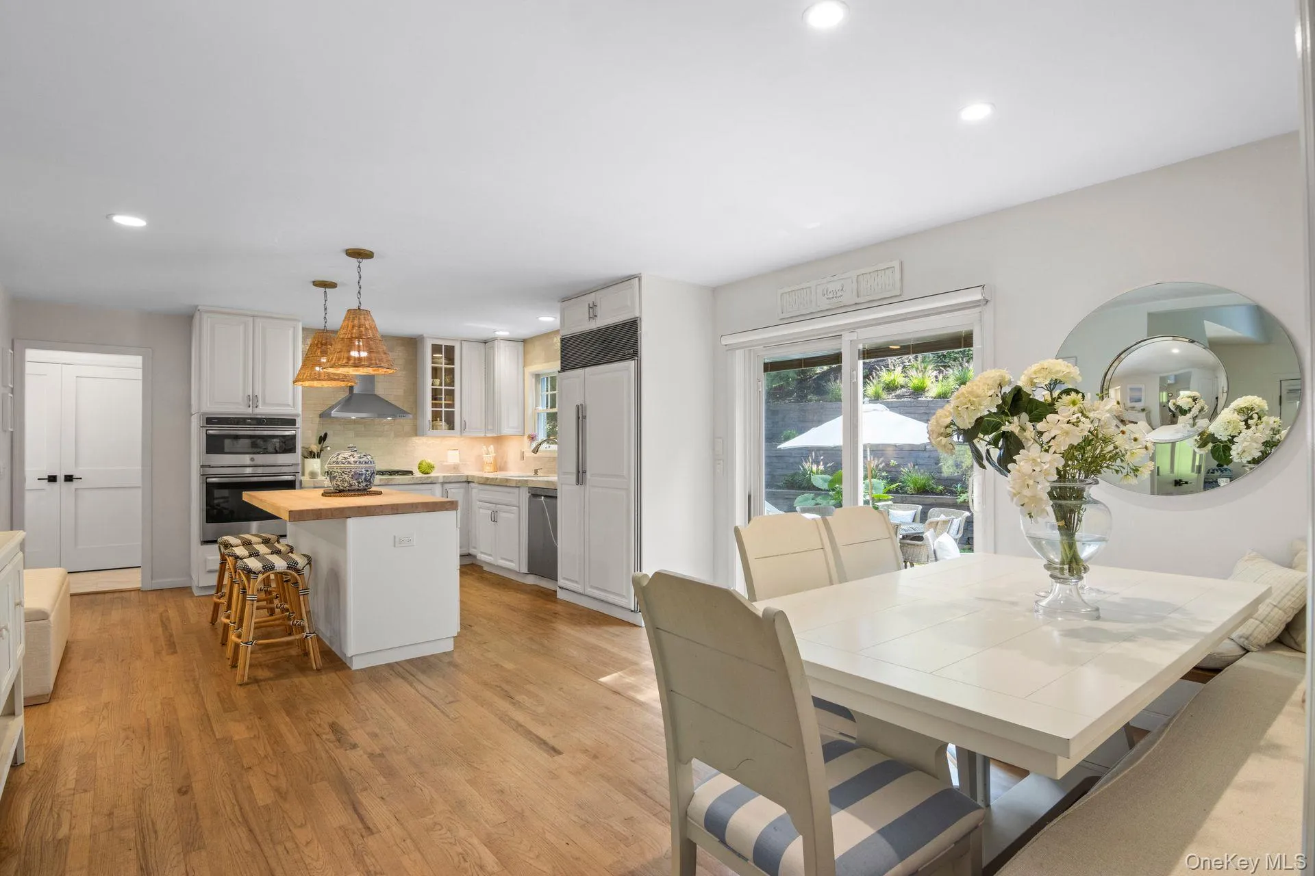Dining space with light wood-type flooring and recessed lighting Dining space with light wood-type flooring and recessed lighting