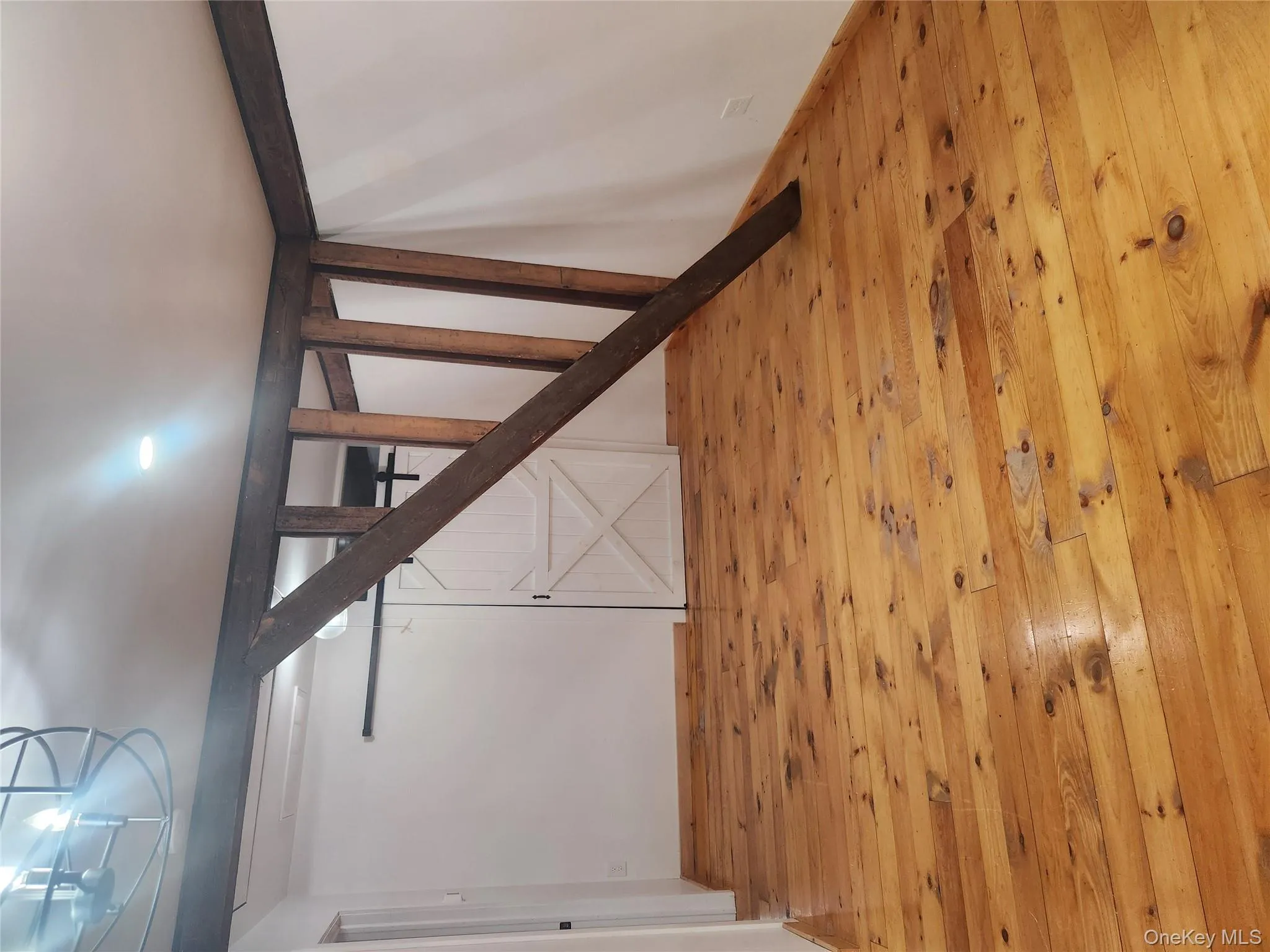 Staircase featuring hardwood / wood-style floors Staircase featuring hardwood / wood-style floors