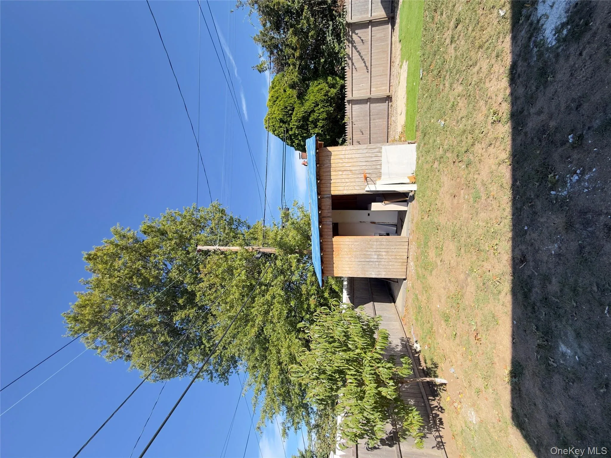 Fenced backyard with a storage unit and a patio Fenced backyard with a storage unit and a patio