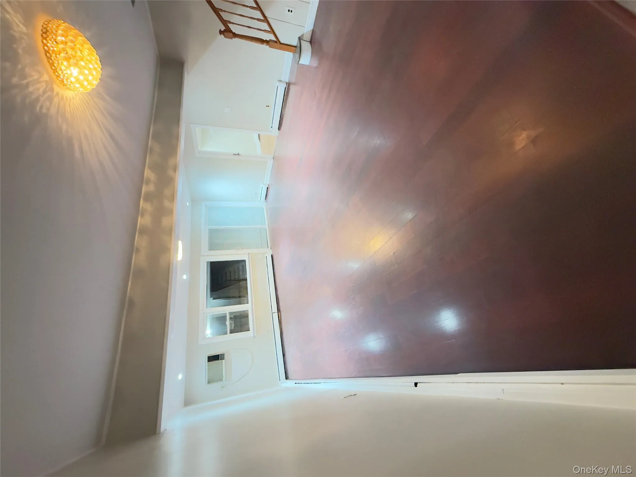 Basement featuring wood finished floors, stairs, and baseboard heating Basement featuring wood finished floors, stairs, and baseboard heating