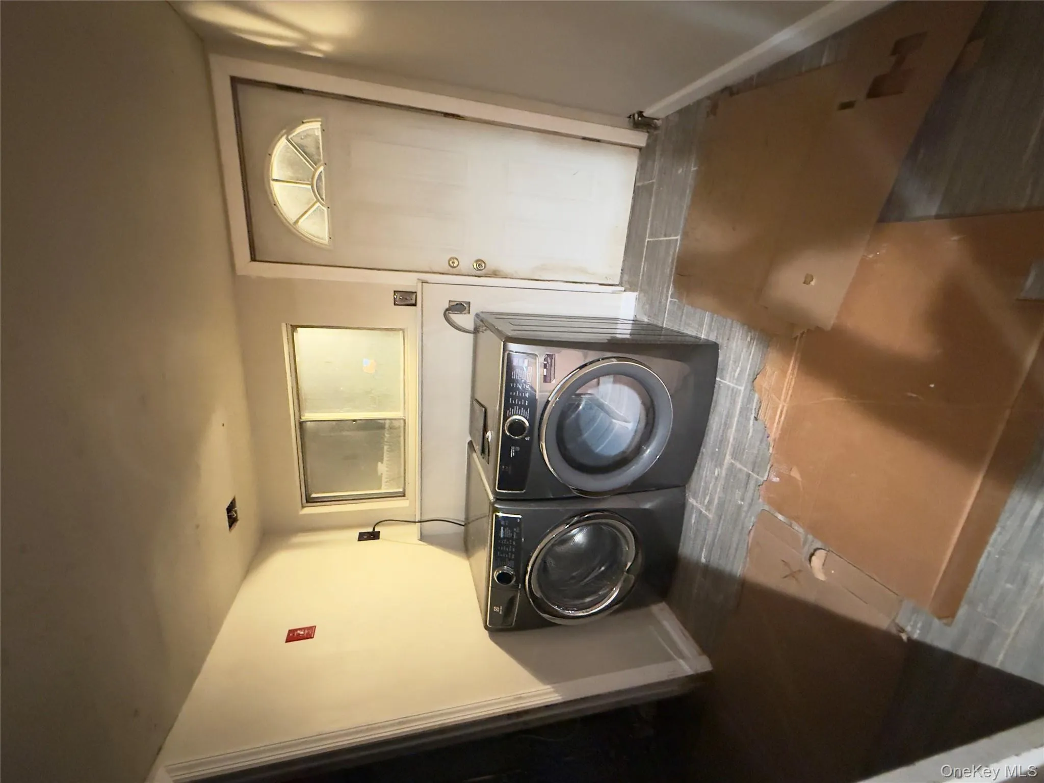 Laundry room with wood finished floors and separate washer and dryer Laundry room with wood finished floors and separate washer and dryer