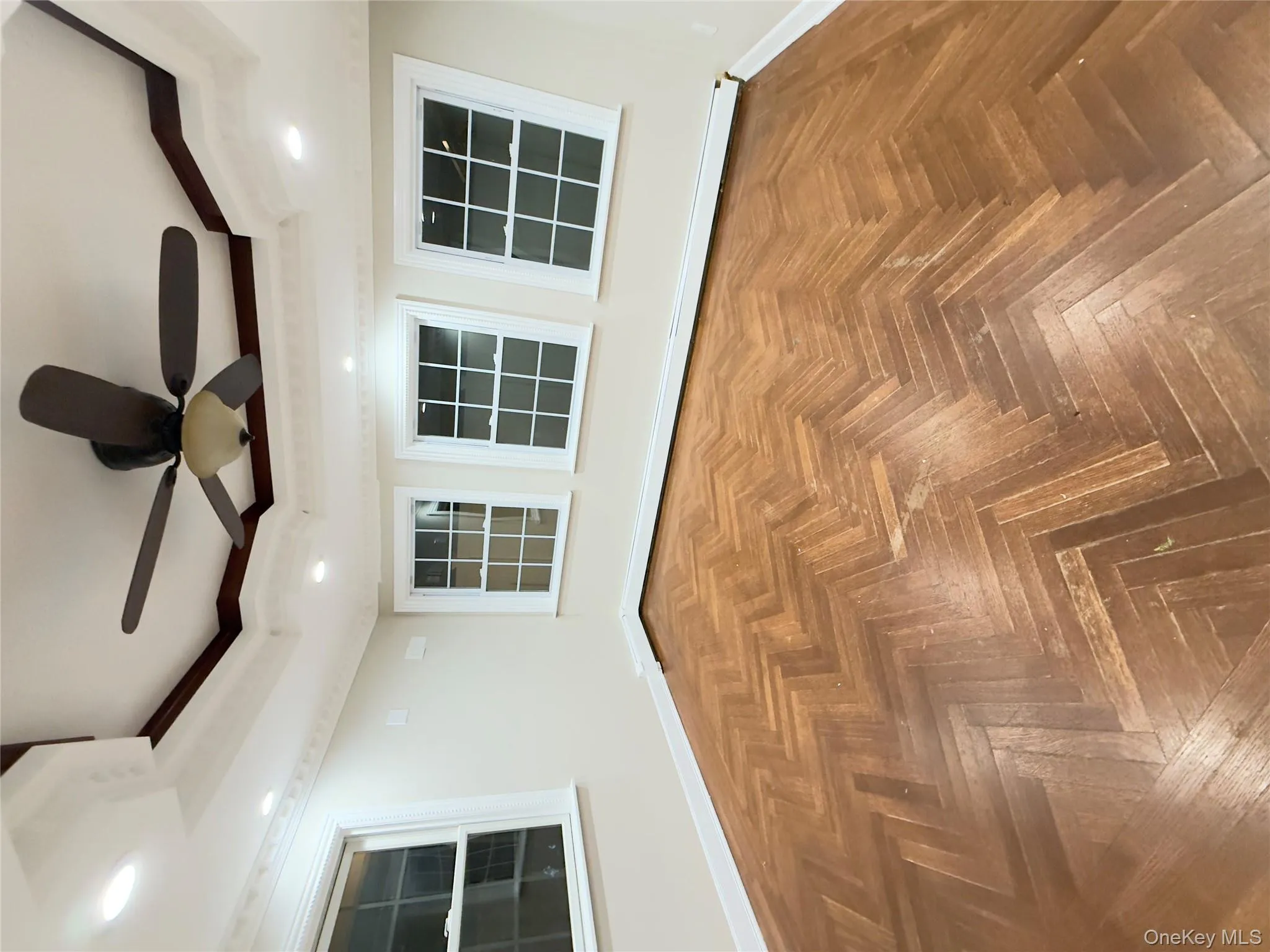 Spare room with a raised ceiling, ceiling fan, recessed lighting, and a baseboard radiator Spare room with a raised ceiling, ceiling fan, recessed lighting, and a baseboard radiator