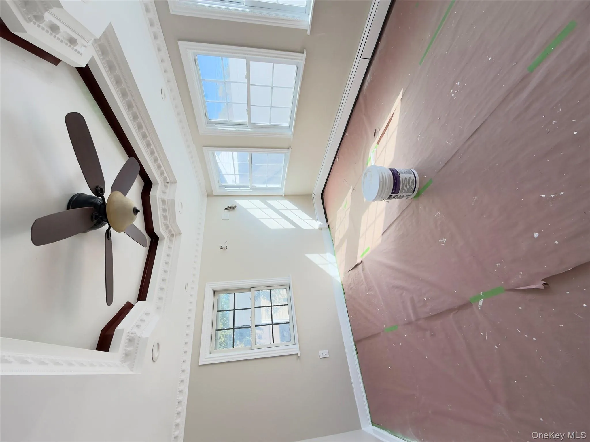 Spare room with a raised ceiling, ornamental molding, a ceiling fan, and a baseboard heating unit Spare room with a raised ceiling, ornamental molding, a ceiling fan, and a baseboard heating unit