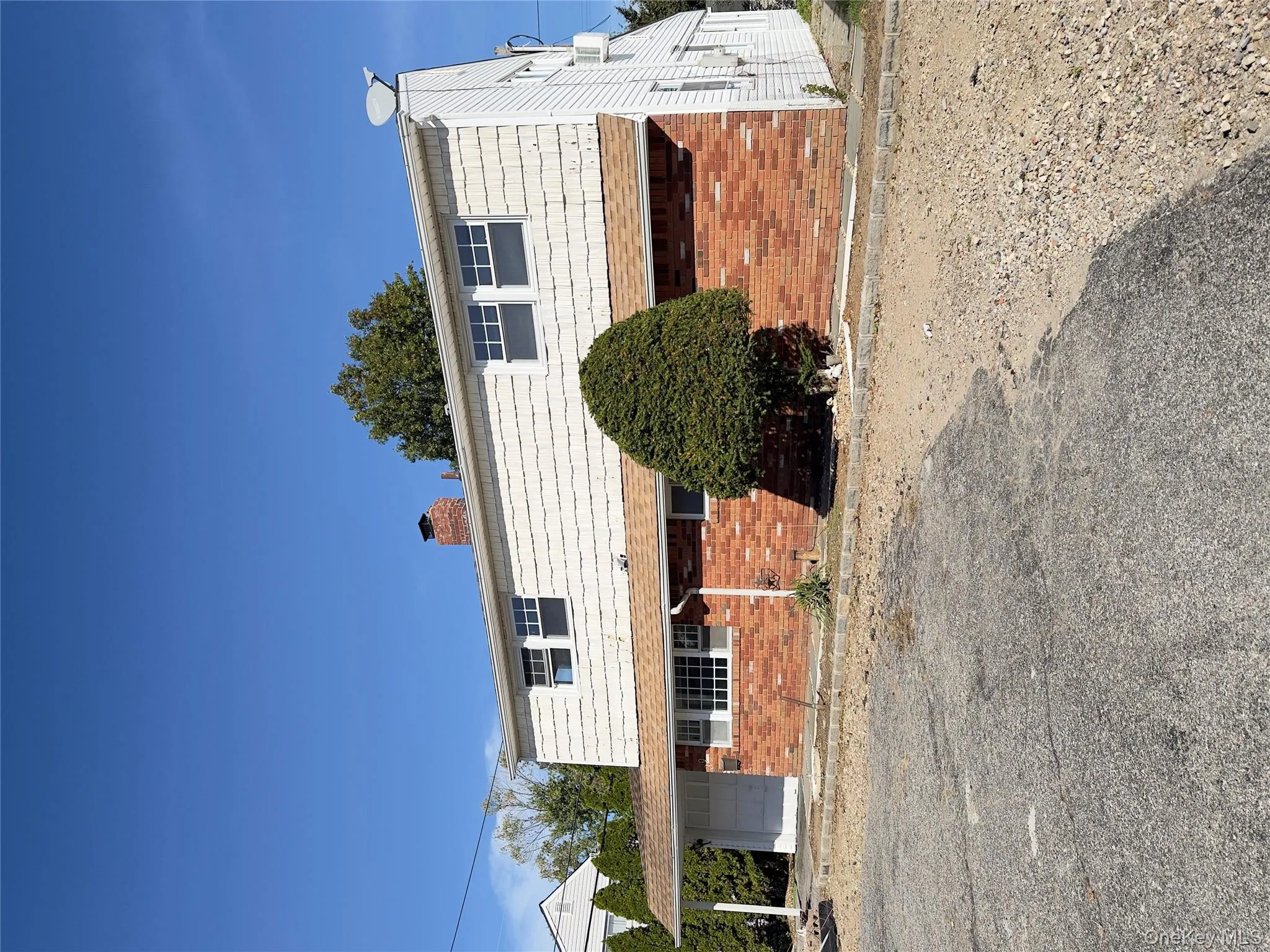 View of side of home with brick siding and a chimney View of side of home with brick siding and a chimney