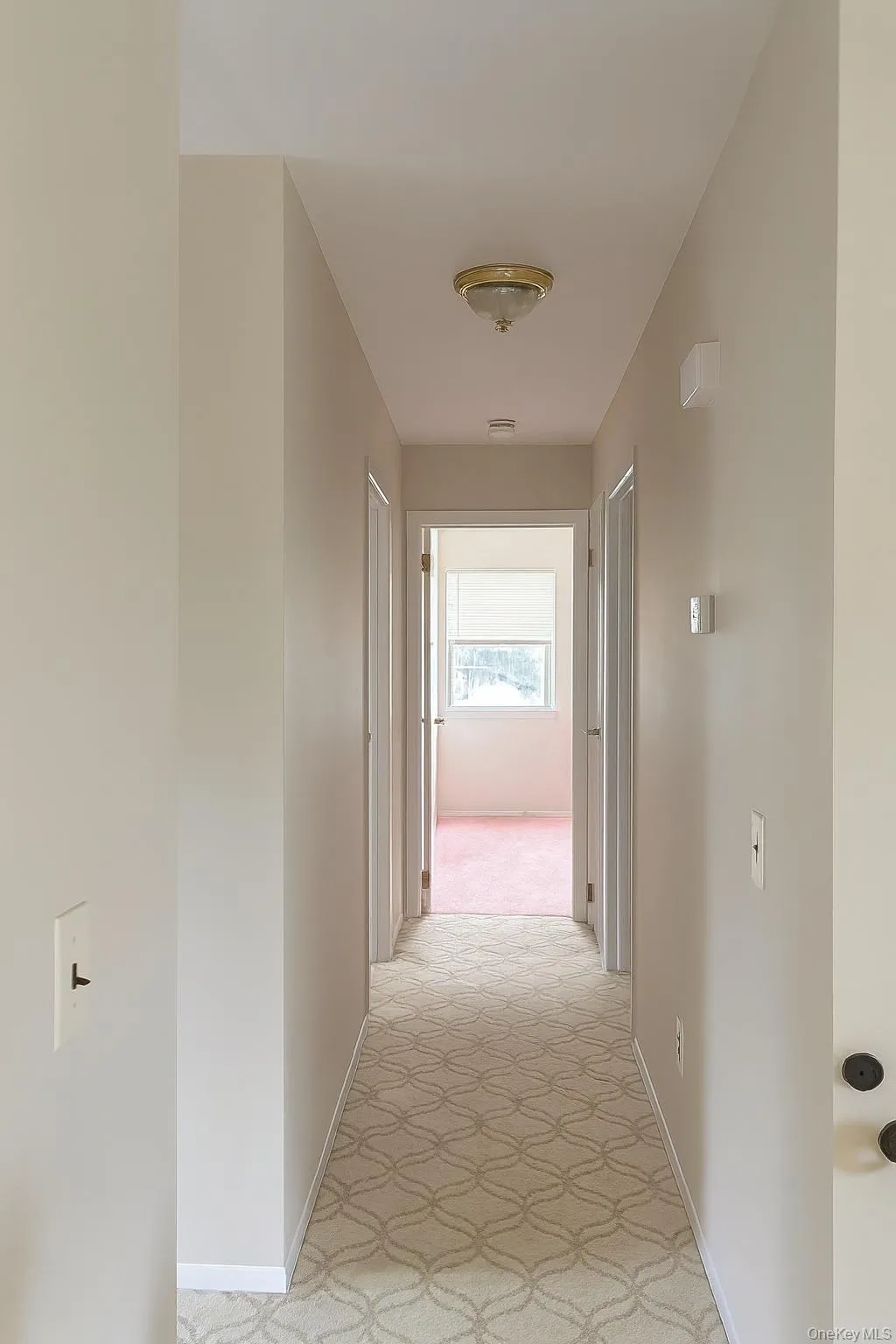 Hall with baseboards and light colored carpet Hall with baseboards and light colored carpet