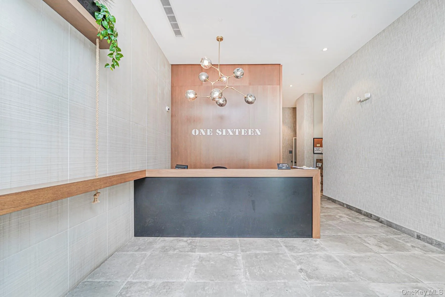 Reception area featuring a chandelier, wallpapered walls, and recessed lighting Reception area featuring a chandelier, wallpapered walls, and recessed lighting