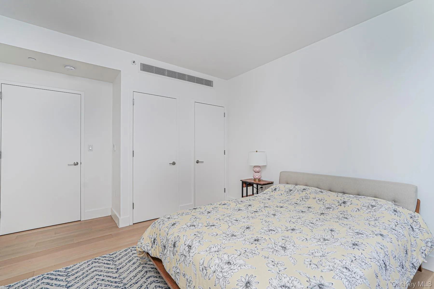 Bedroom with light wood-type flooring and baseboards Bedroom with light wood-type flooring and baseboards