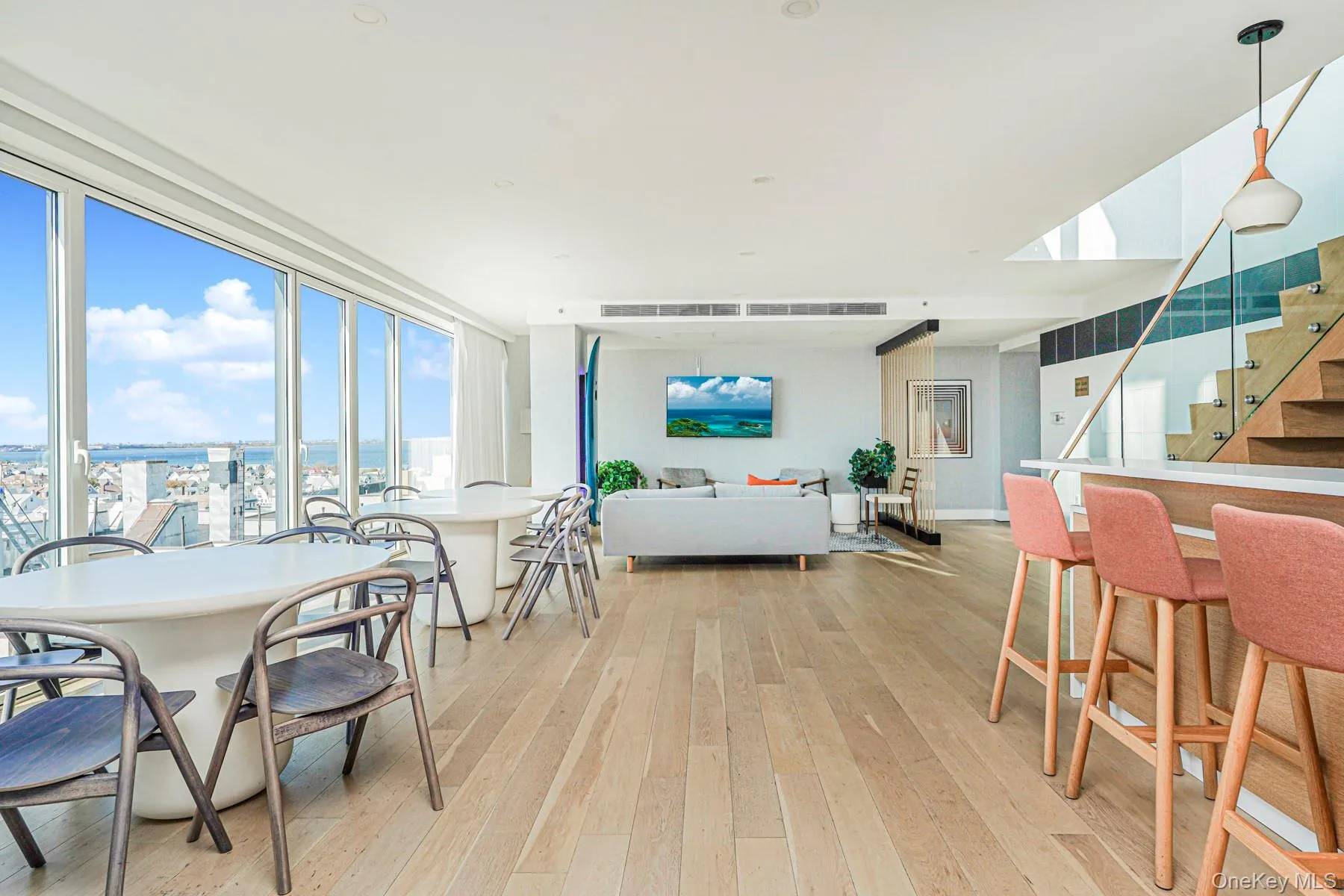 Dining area with stairway, light wood-style floors, and a water view Dining area with stairway, light wood-style floors, and a water view