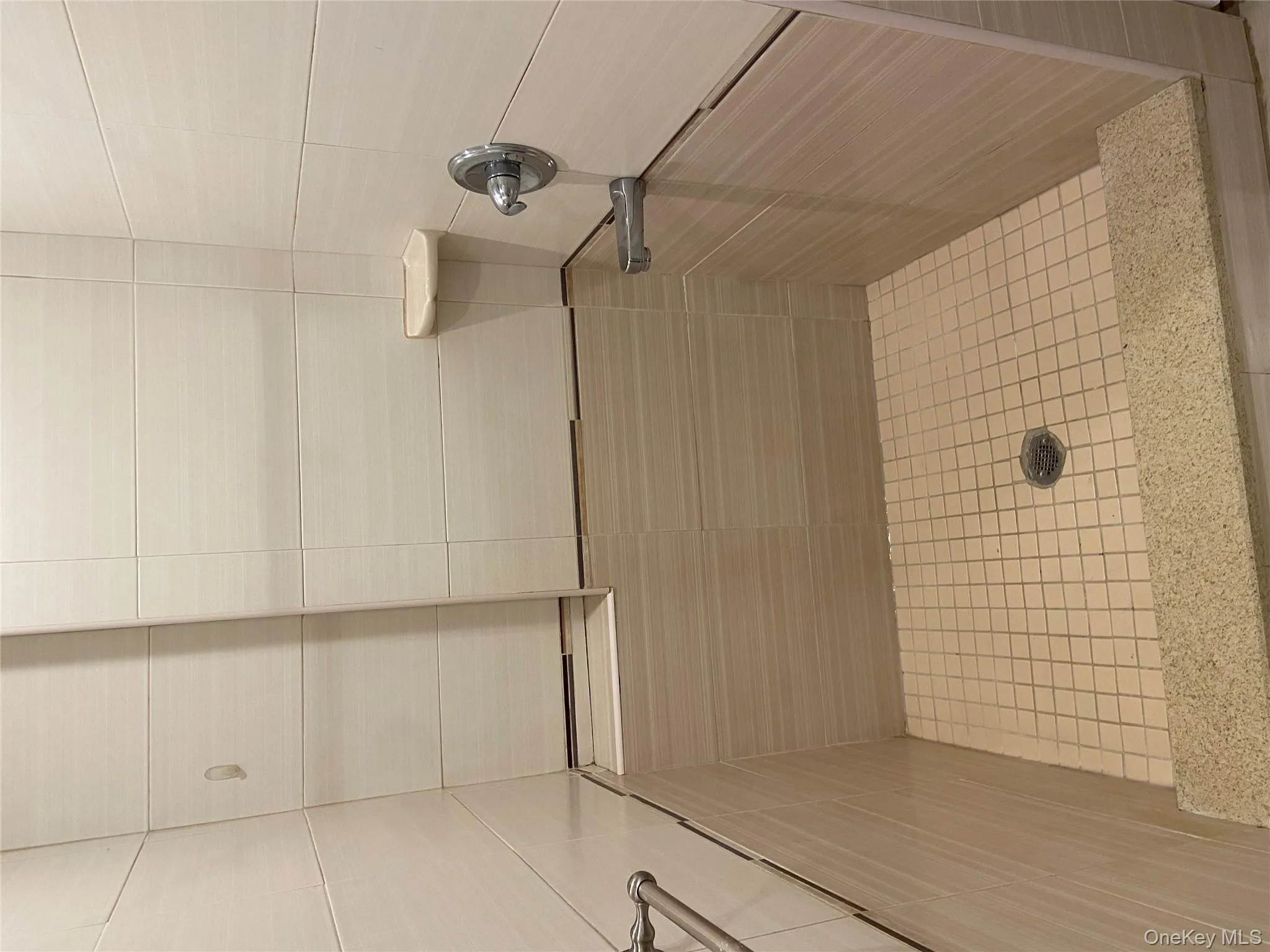 Bathroom featuring a tile shower Bathroom featuring a tile shower