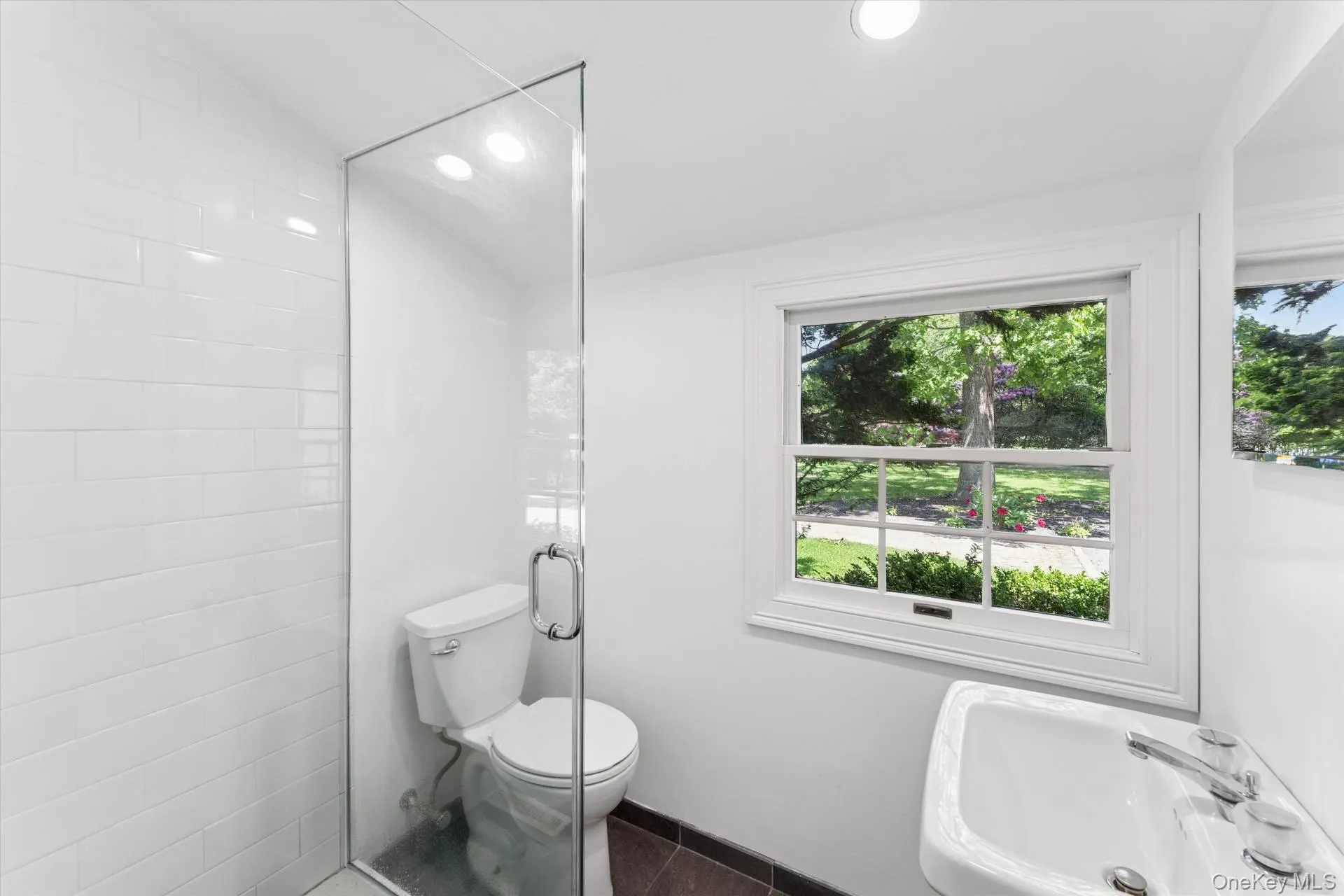 Full bath featuring a shower stall, dark tile patterned floors, and recessed lighting Full bath featuring a shower stall, dark tile patterned floors, and recessed lighting