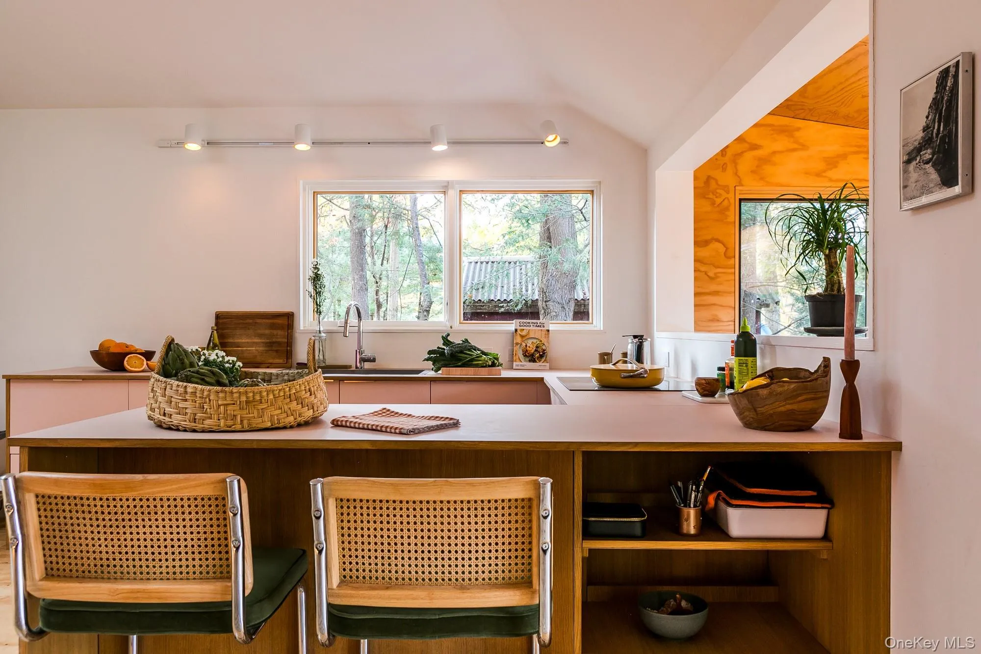 Kitchen featuring lofted ceiling, light countertops, and a peninsula Kitchen featuring lofted ceiling, light countertops, and a peninsula