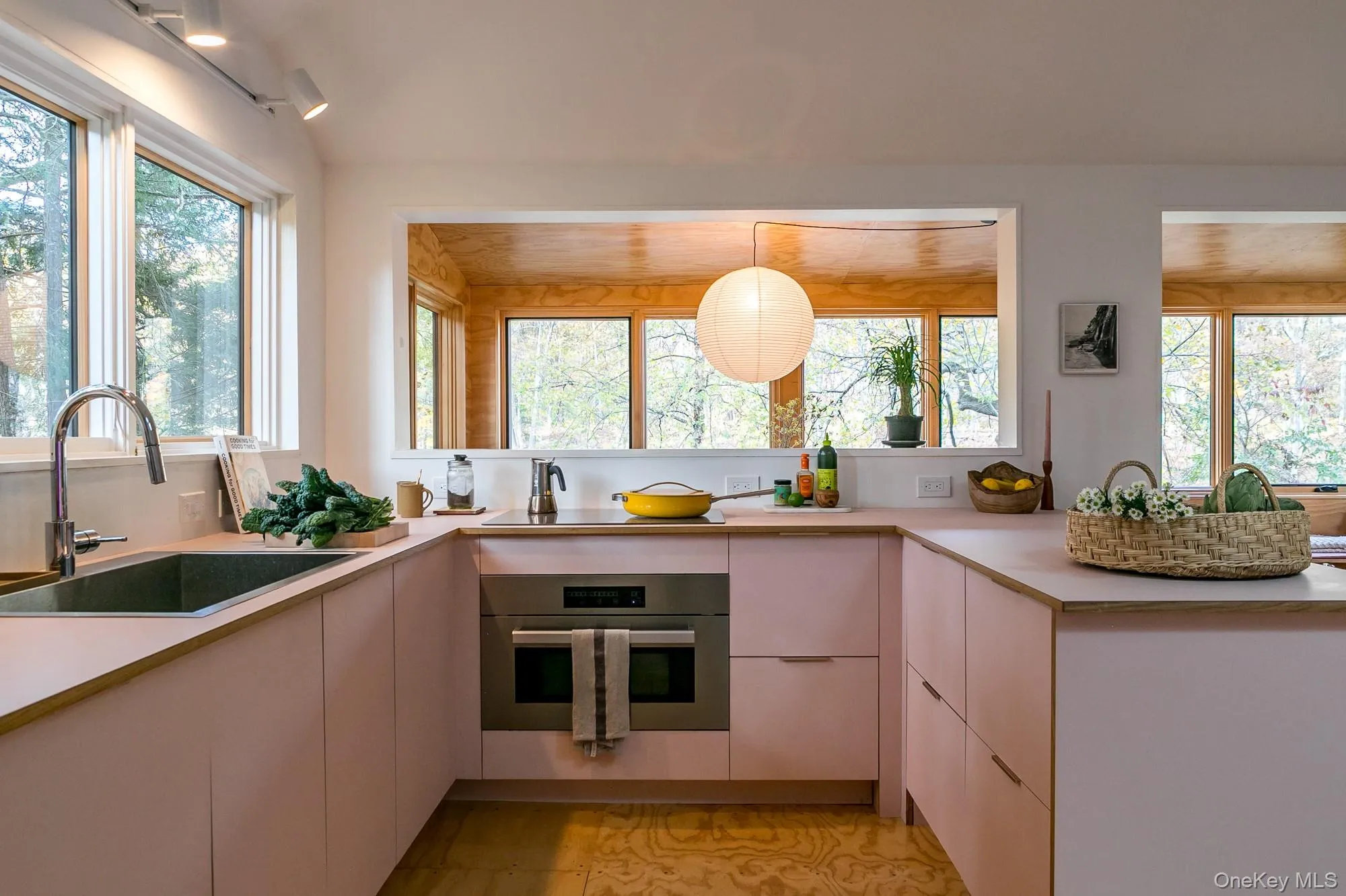 Kitchen with stainless steel oven, healthy amount of natural light, light countertops, and pendant lighting Kitchen with stainless steel oven, healthy amount of natural light, light countertops, and pendant lighting