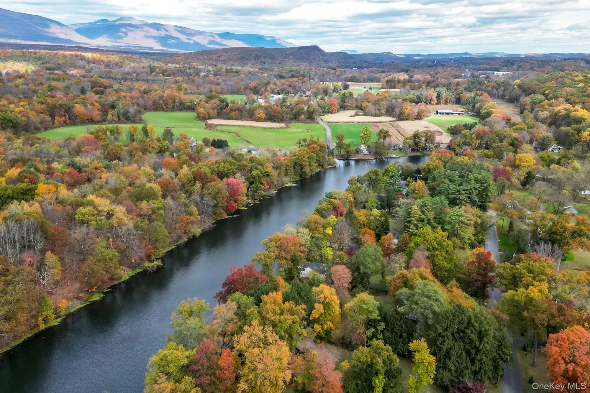 Drone / aerial view of a water and mountain view and a heavily wooded area Drone / aerial view of a water and mountain view and a heavily wooded area