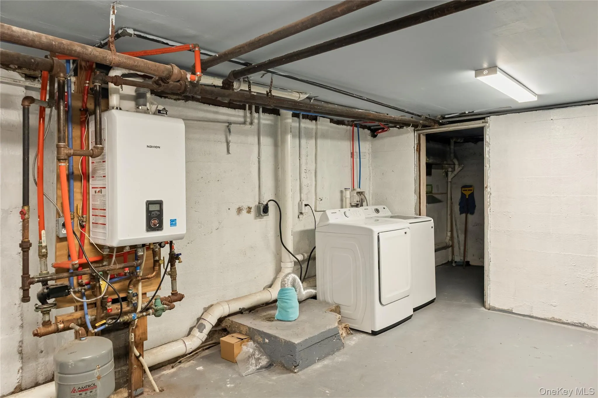 Unfinished basement featuring washer / dryer and water heater Unfinished basement featuring washer / dryer and water heater