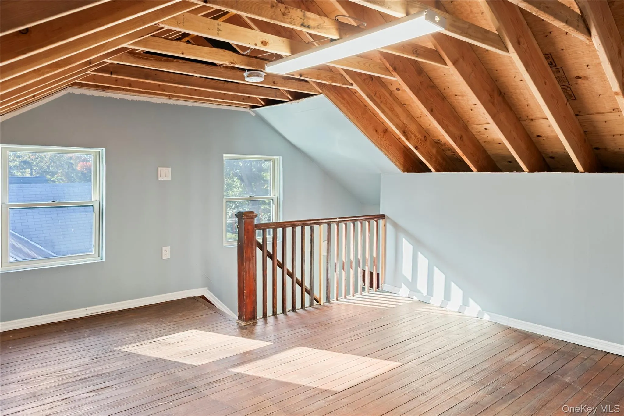 Additional living space featuring vaulted ceiling and hardwood / wood-style floors Additional living space featuring vaulted ceiling and hardwood / wood-style floors