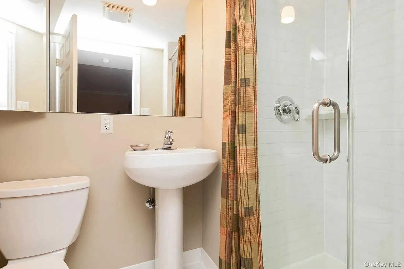 Full bath featuring a stall shower and toilet Full bath featuring a stall shower and toilet