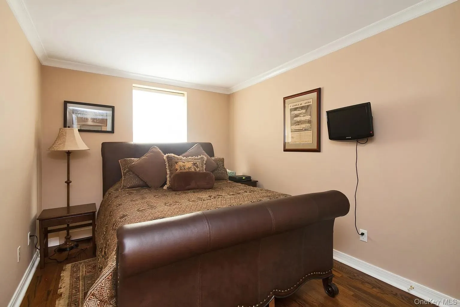 Bedroom with crown molding and dark wood-type flooring Bedroom with crown molding and dark wood-type flooring
