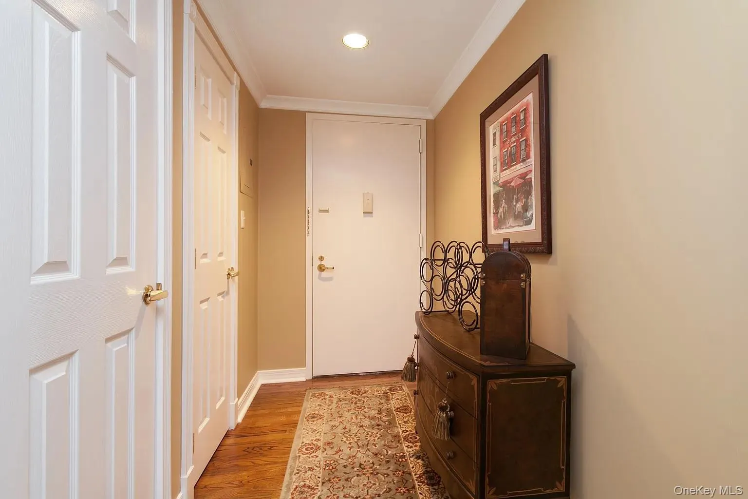 Doorway to outside with wood finished floors, crown molding, and recessed lighting Doorway to outside with wood finished floors, crown molding, and recessed lighting