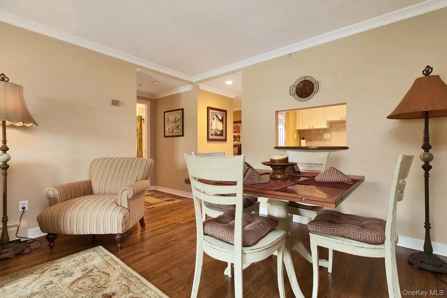 Dining space featuring crown molding and dark wood finished floors Dining space featuring crown molding and dark wood finished floors
