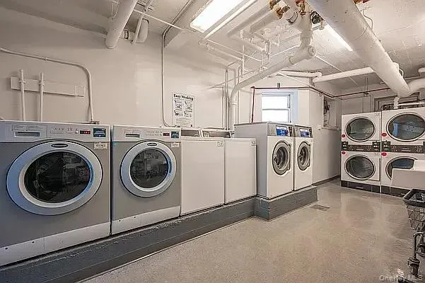 Communal laundry room featuring washing machine and dryer and stacked washing machine and dryer Communal laundry room featuring washing machine and dryer and stacked washing machine and dryer