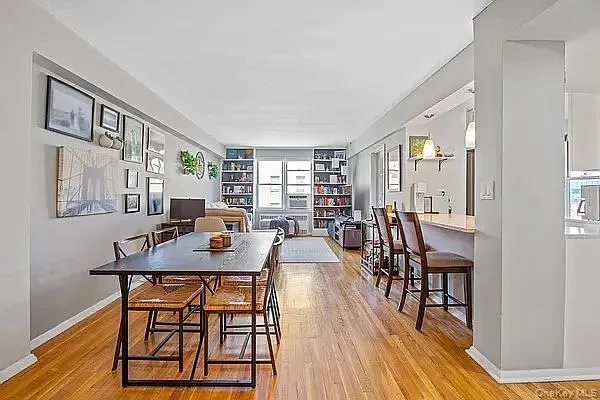 Dining room with light wood-style flooring and baseboards Dining room with light wood-style flooring and baseboards