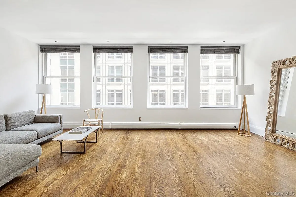 Living area featuring light wood finished floors and baseboard heating Living area featuring light wood finished floors and baseboard heating
