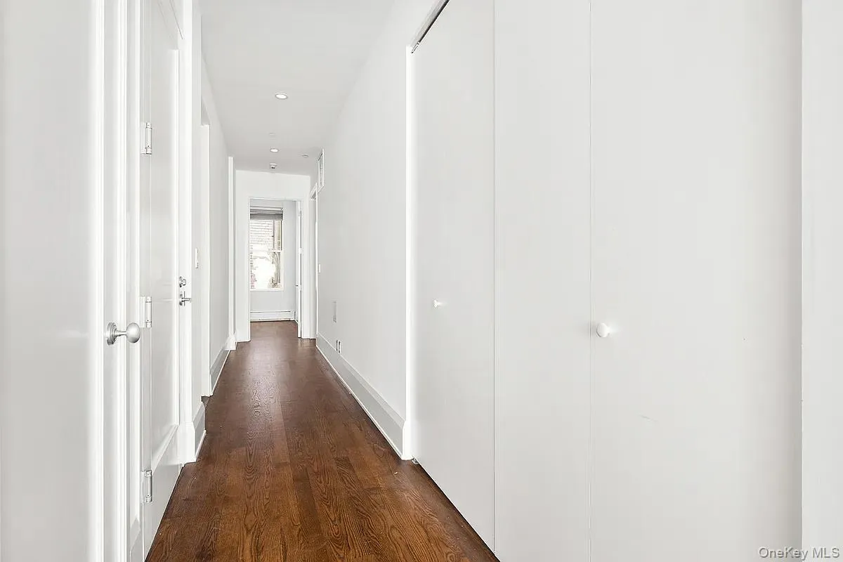 Hall featuring dark wood-style floors and recessed lighting Hall featuring dark wood-style floors and recessed lighting