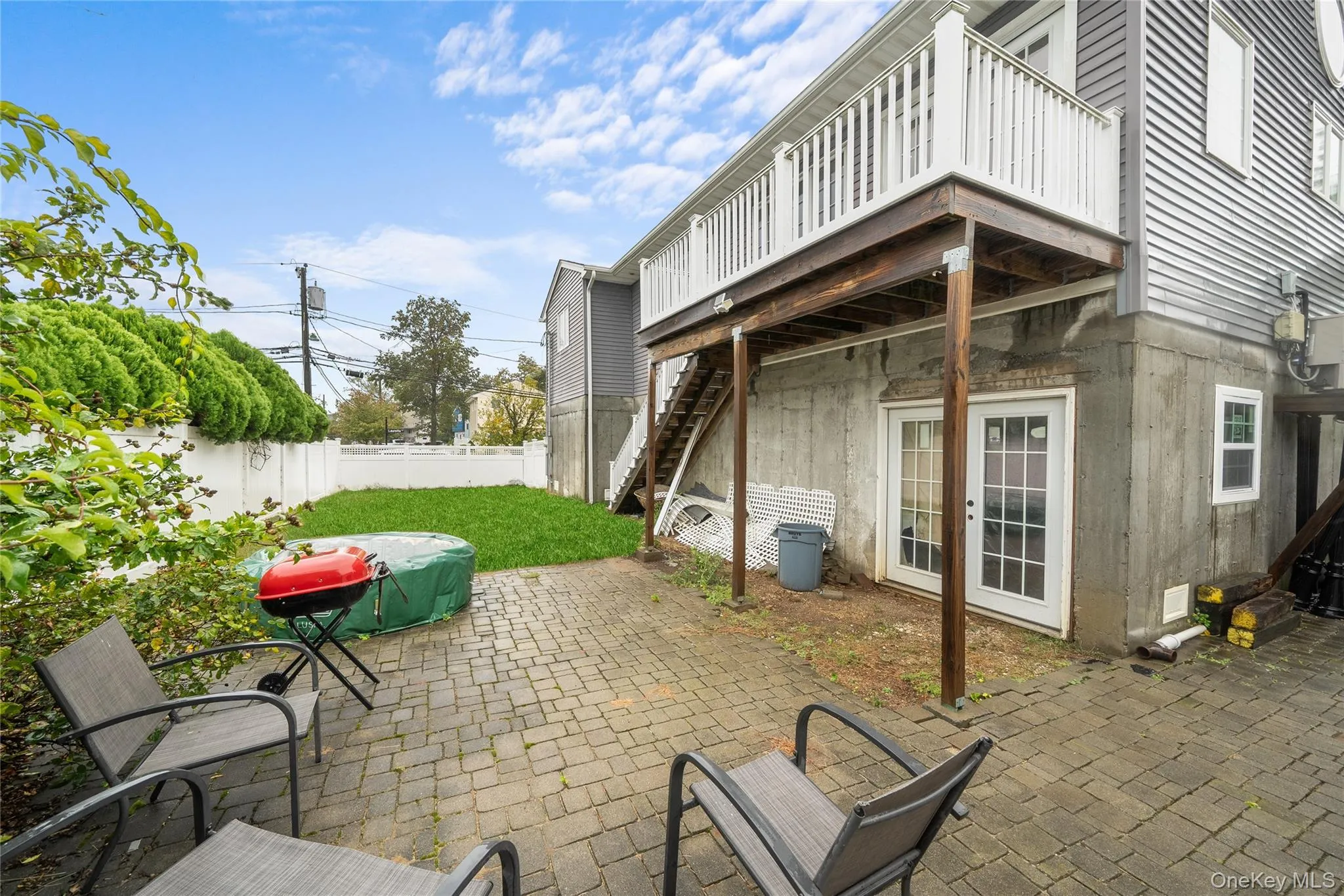 Fenced backyard with stairs and a patio Fenced backyard with stairs and a patio