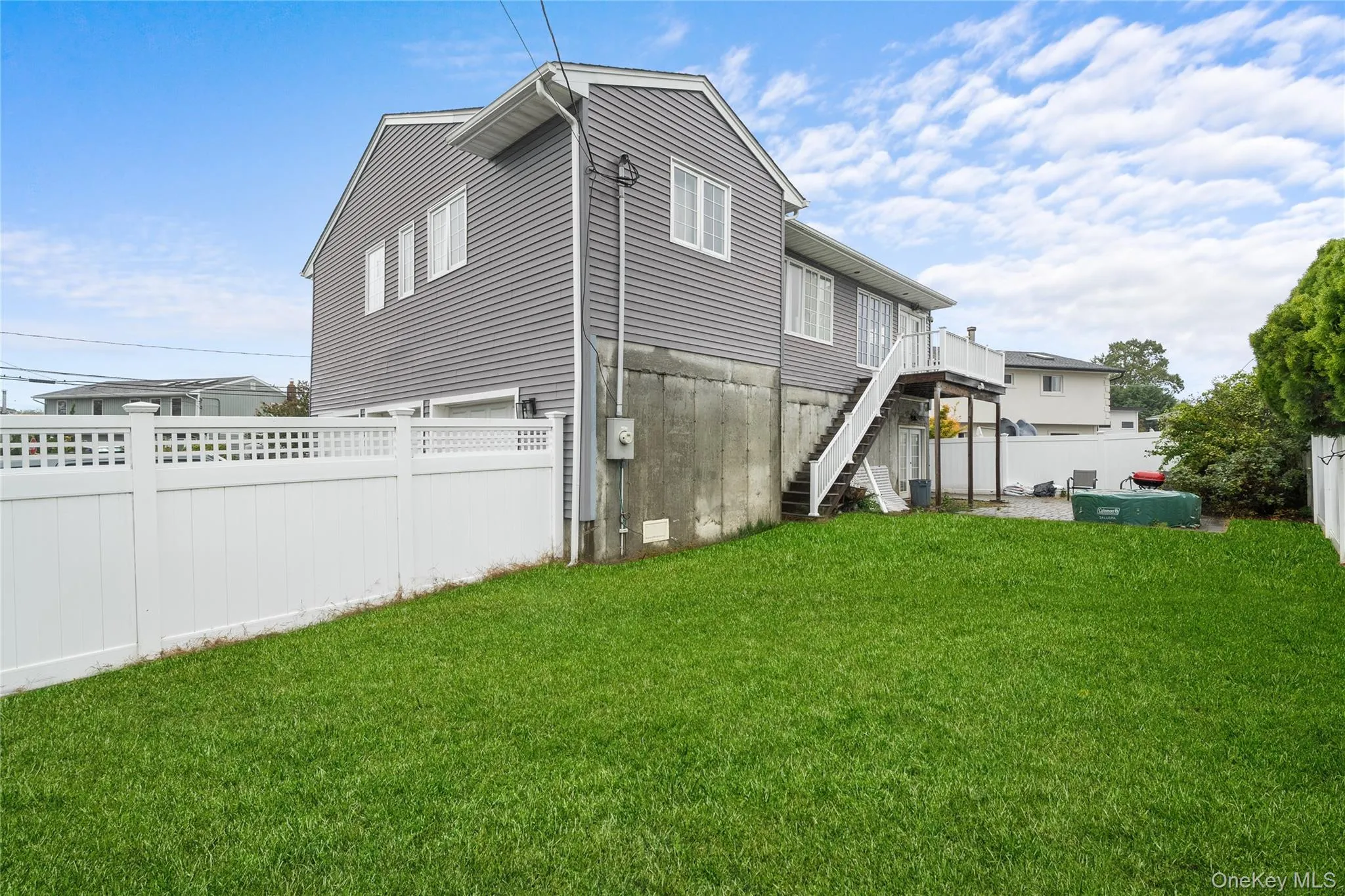 Rear view of property with stairway and a fenced backyard Rear view of property with stairway and a fenced backyard
